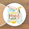 A white coaster with a colorful graphic design featuring various kitchen utensils and text.