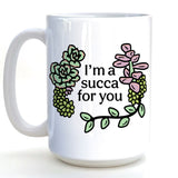 A white ceramic mug with a floral design and text printed on it.