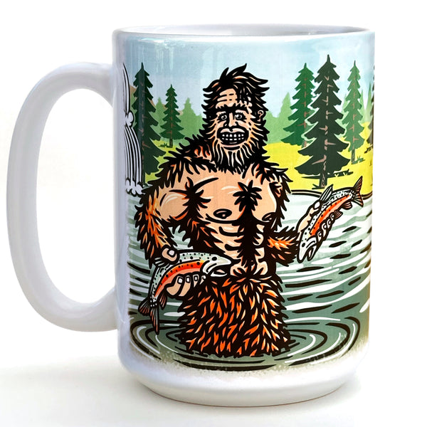 A mug featuring an illustration of a large, furry creature with a beard and holding fish in its hands, set against a forest backdrop.