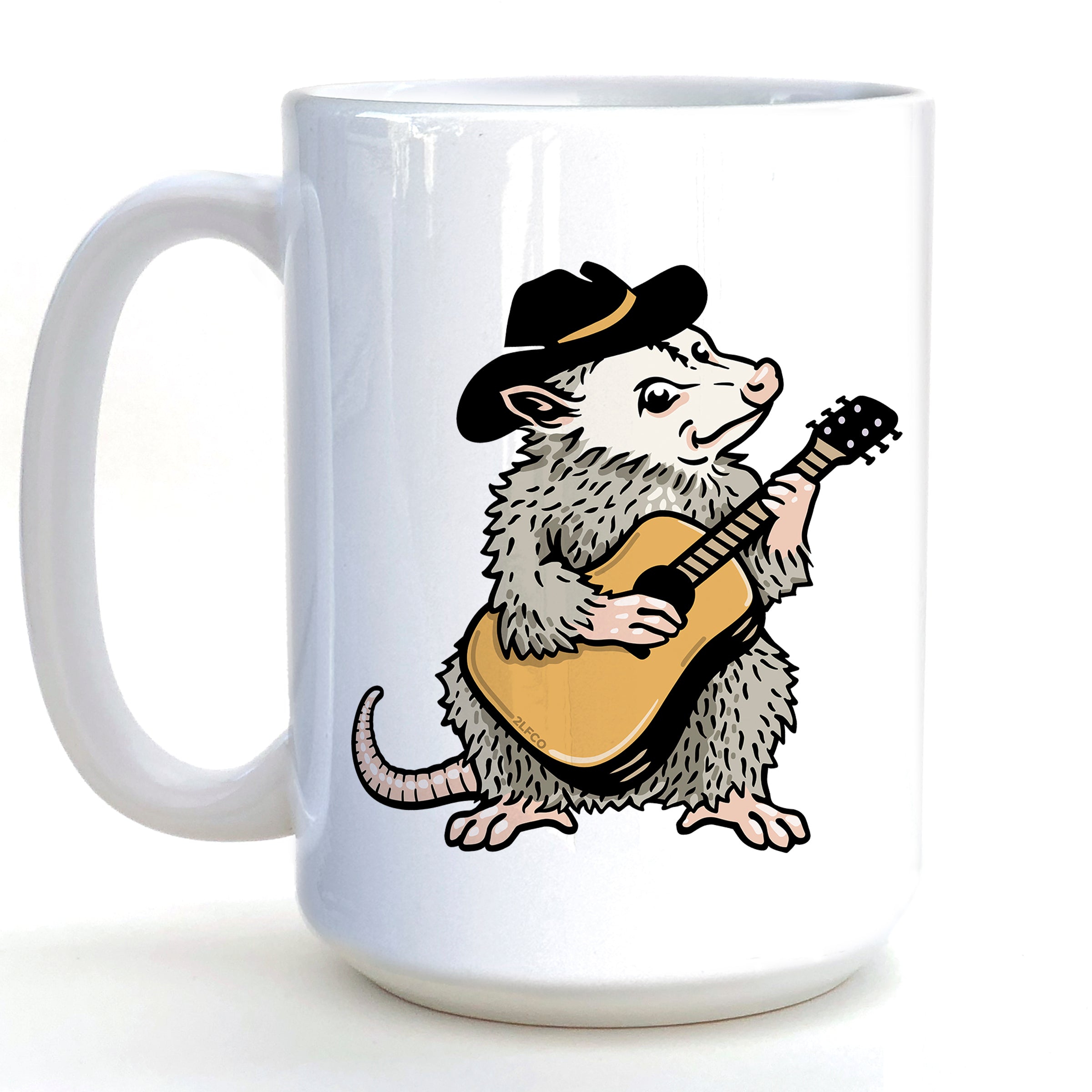 A white ceramic mug with a cartoon image of a furry opossum playing a guitar.