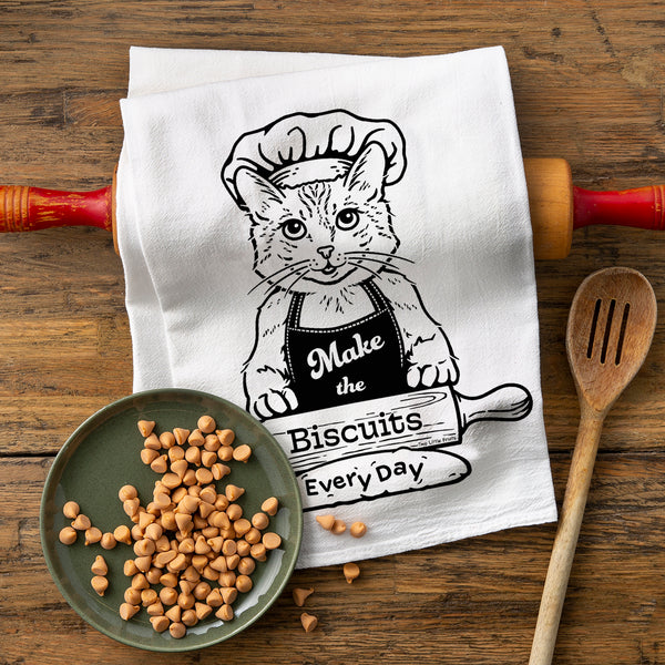 Whimsical Kitchen Decor – Eco-Friendly Cat Chef Cotton Tea Towel featuring a playful cat in a chef's outfit with the phrase 'Make the Biscuits Every Day' above a rolling pin, perfect for adding charm to your kitchen.