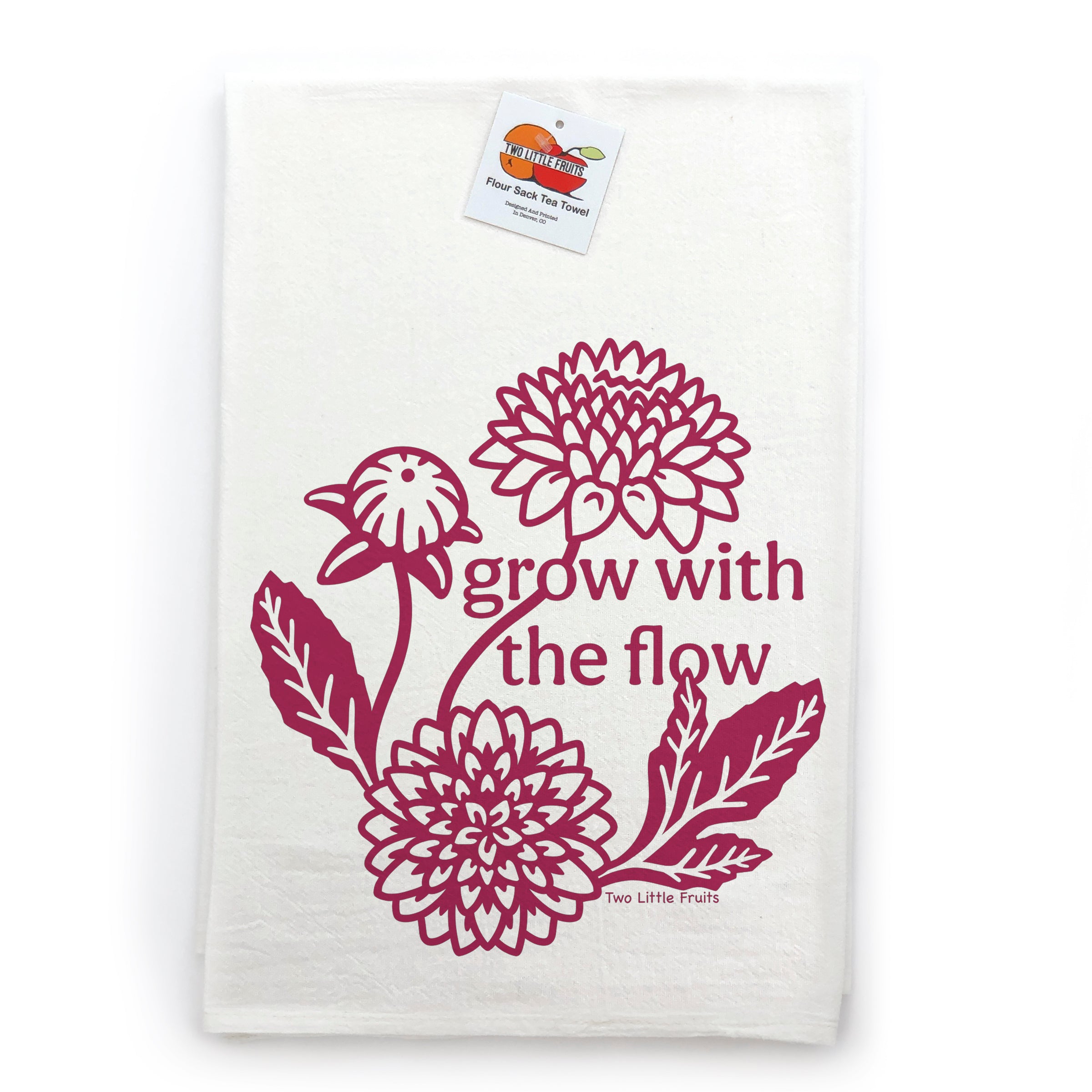 a white towel with a maroon design depicting flowers and the text "grow with the flow" printed on it.