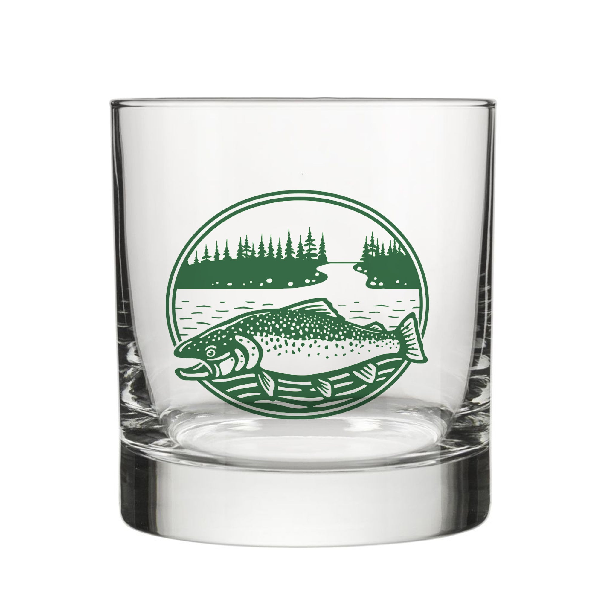 A clear glass with a green circular design featuring a fish and a landscape with trees.