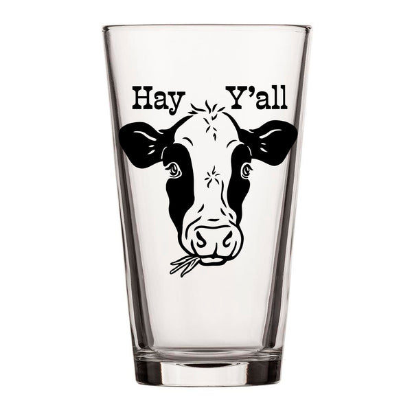 Single cow beer pint glass adorned with 'Hay Y'all' above a playful cow illustration, showcasing its clear design and inviting clean lines.