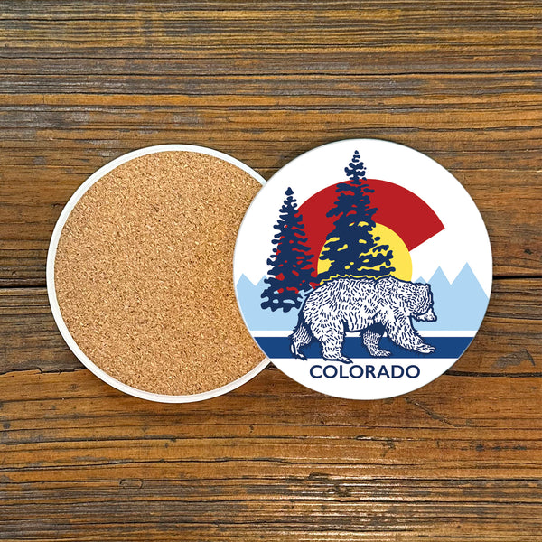 Close-up view of a Colorado bear coaster design, showcasing a bear against a vibrant Colorado flag background with nature elements.
