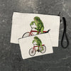 Cheerful frog pencil pouch featuring a vibrant illustration of a frog riding a red bicycle, displayed in two sizes on a textured background.