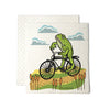 Frog On A Bike Swedish Dishcloth, a cheerful compostable kitchen cloth featuring a playful frog design on a bicycle, perfect for eco-friendly cleaning.
