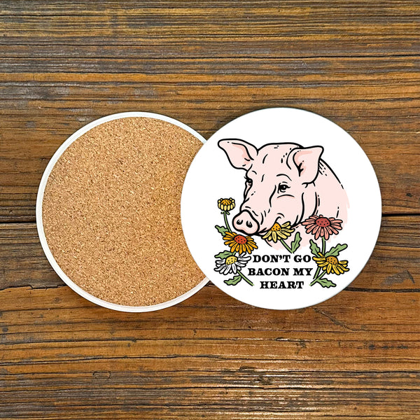 Top view of a pig themed coaster showcasing a charming pig design with flowers, labeled 'DON'T GO BACON MY HEART'. Ideal for coffee or cocktails.