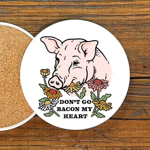 Pig themed coaster featuring a cute pig illustration surrounded by colorful flowers and the phrase 'DON'T GO BACON MY HEART'. Perfect for adding charm to your table.