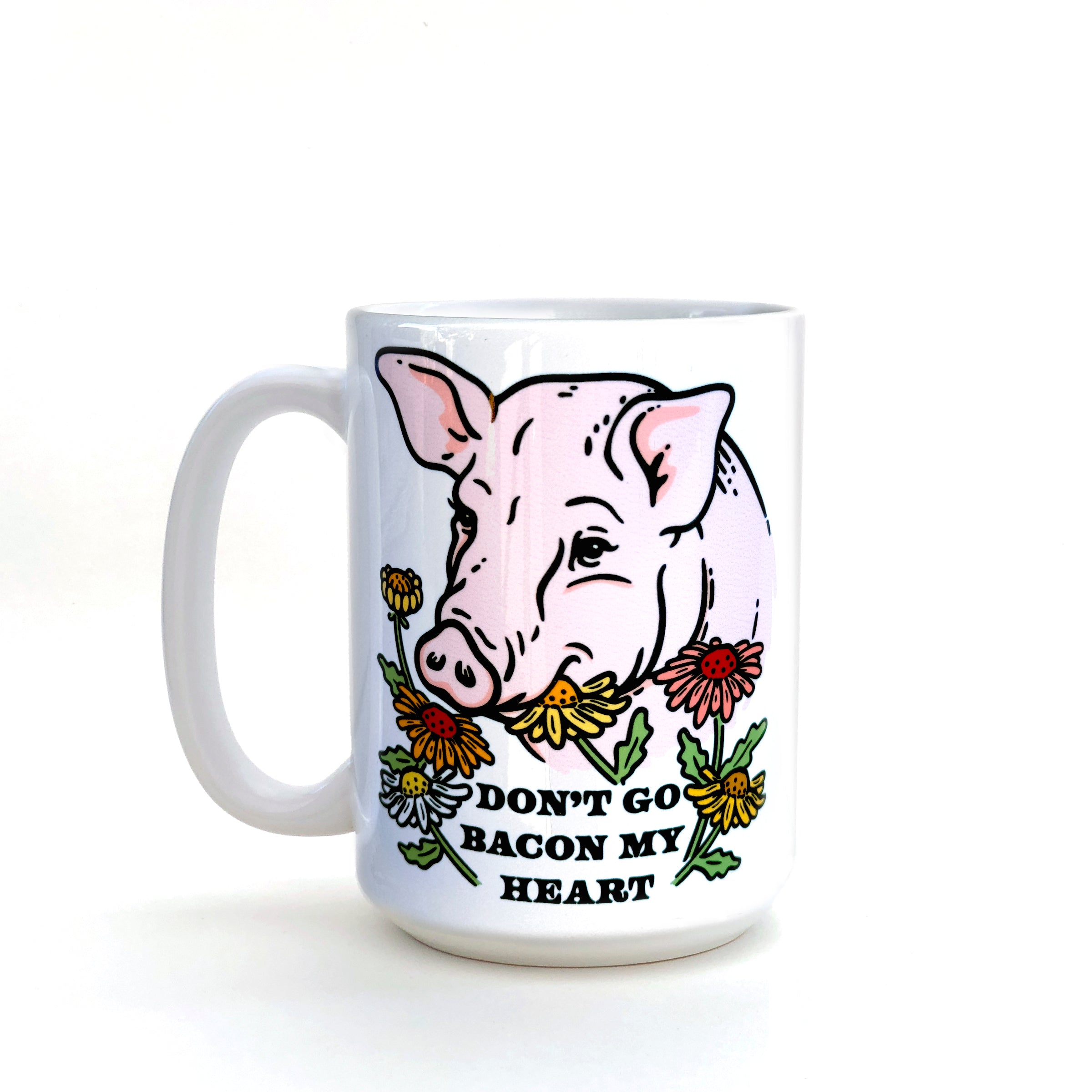 Funny pig coffee mug showcasing a playful pig design with flowers and the humorous phrase 'DON'T GO BACON MY HEART'.