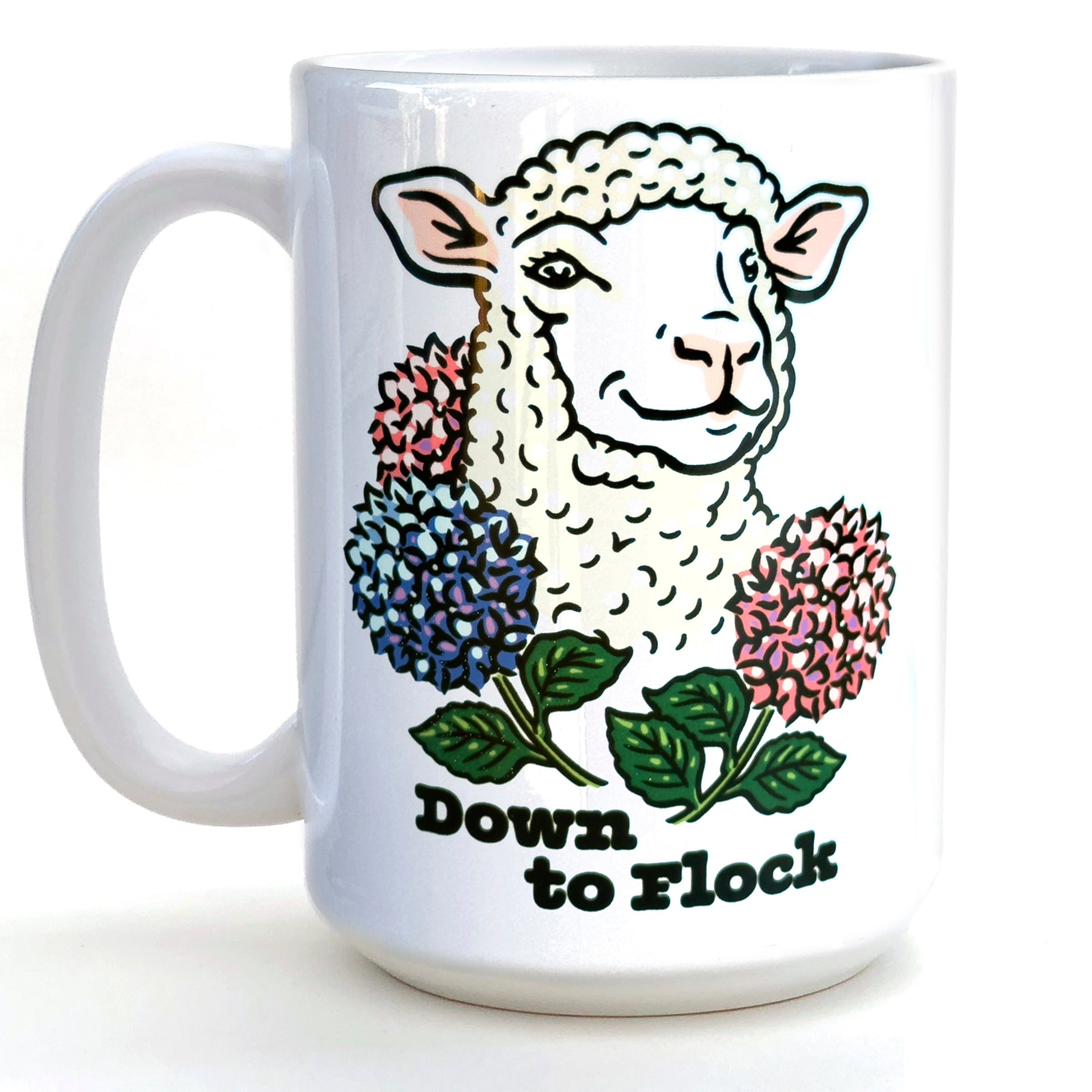 Cute ceramic coffee mug featuring a smiling lamb surrounded by colorful flowers, with the phrase 'Down to Flock' printed on it. Ideal for coffee lovers looking for a whimsical touch.