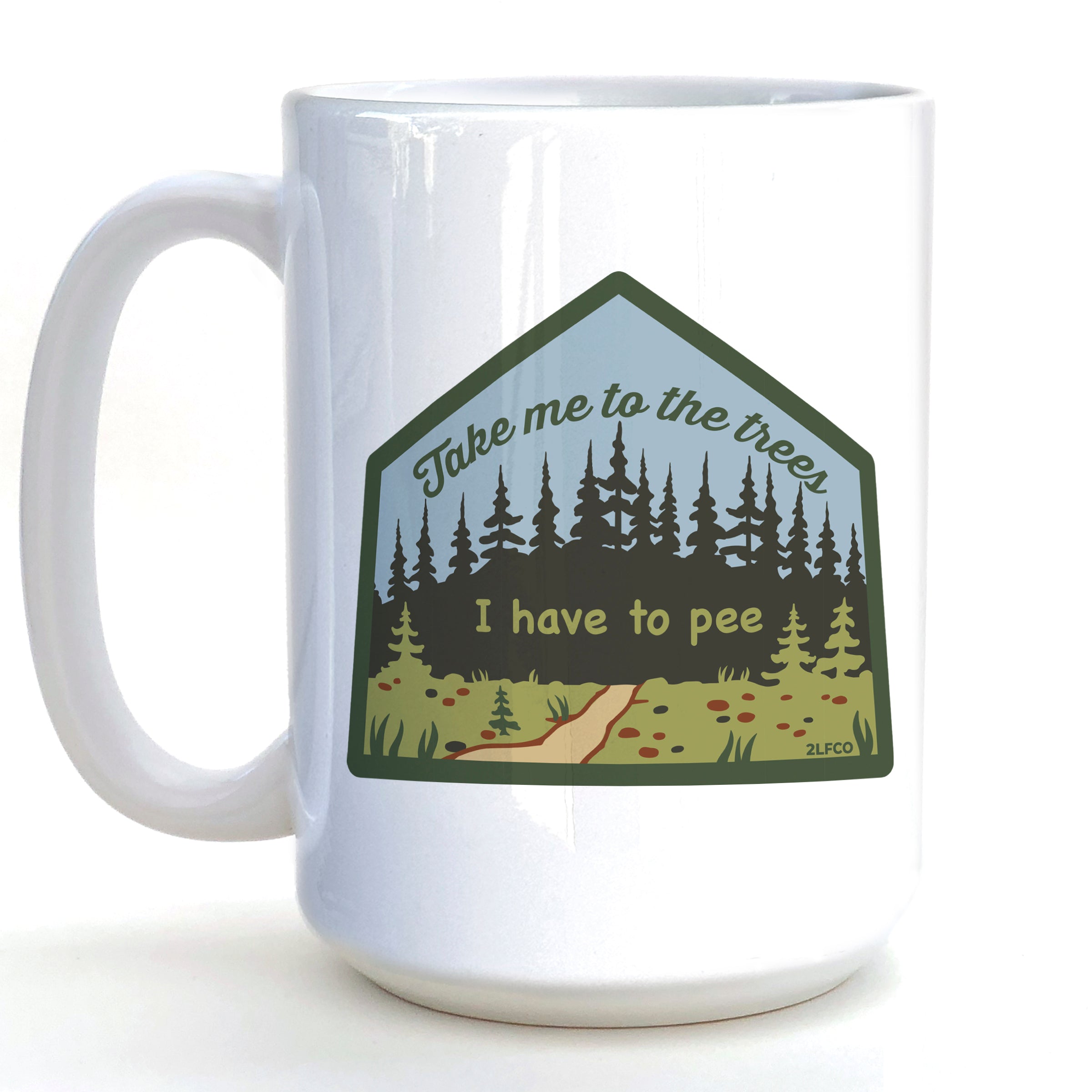 A white ceramic mug with a graphic design featuring a forest scene and the text "Take me to the trees" and "I have to pee" printed on it.