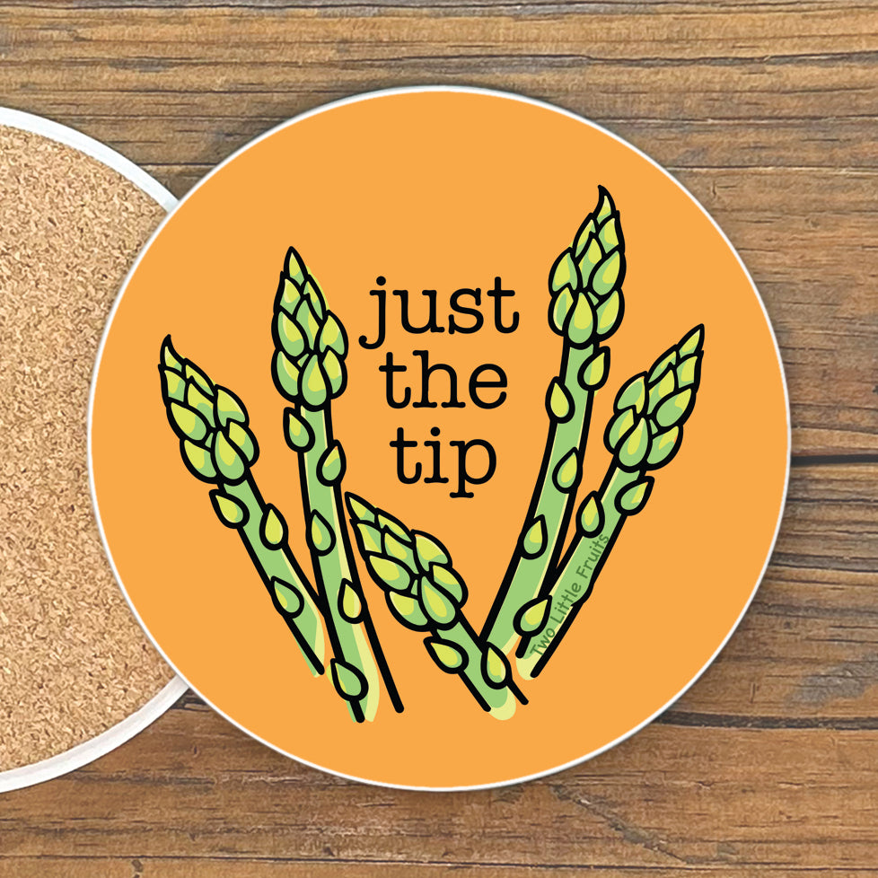 a round coaster with an illustration of green asparagus stalks and the text 