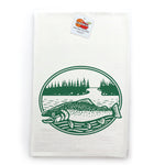 a white towel with a green and white design depicting a fish swimming in a river surrounded by trees.
