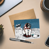 Astronaut Dog Greeting Card featuring a playful pug in a spacesuit, set against a cosmic background, ideal for dog lovers, includes a brown envelope.