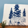 Adorable Bear Kitchen Towel – Hand-Drawn Design in Royal Blue with a playful bear illustration and pine forest, perfect for functional and decorative use in any kitchen.