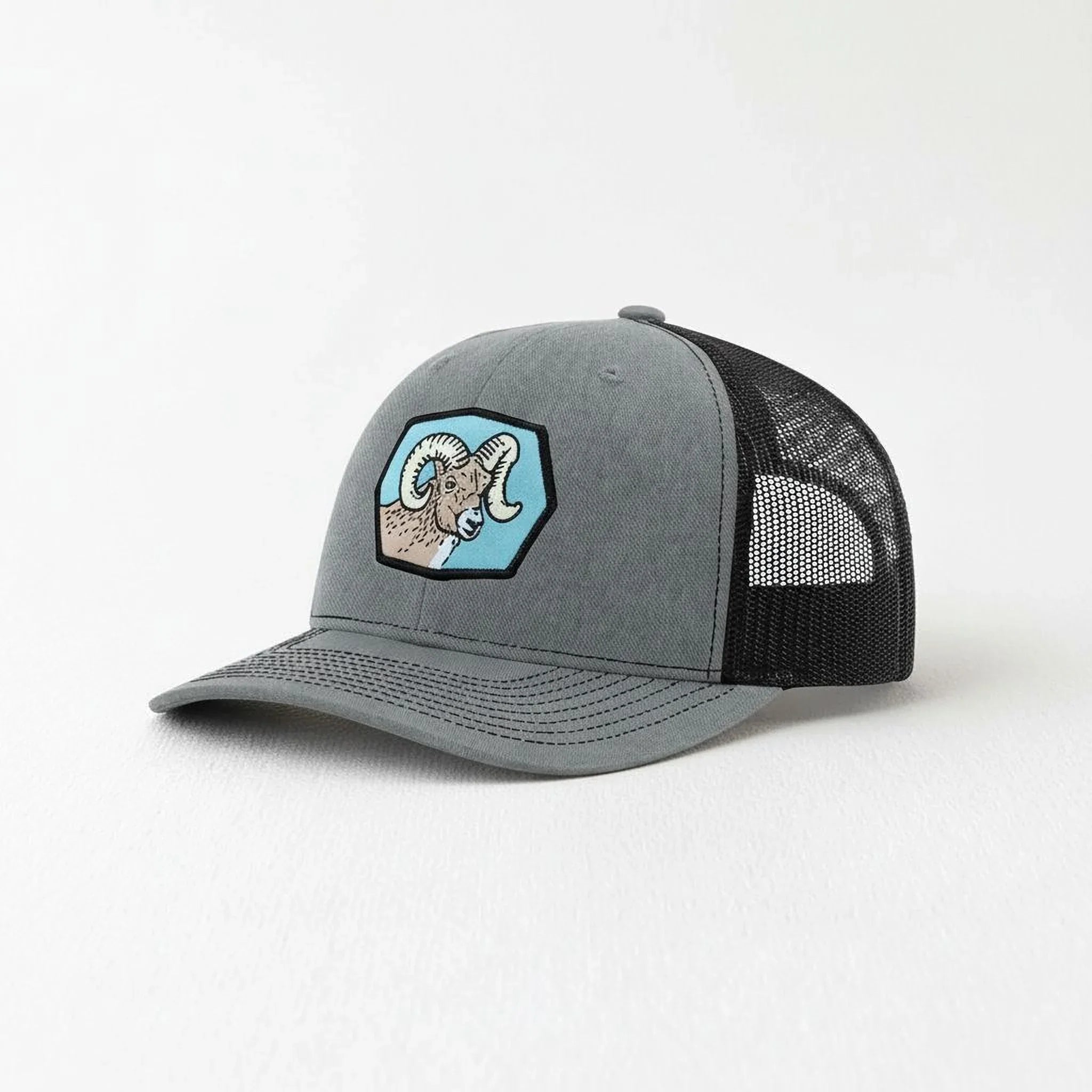 A gray baseball cap with a black mesh panel on the side.