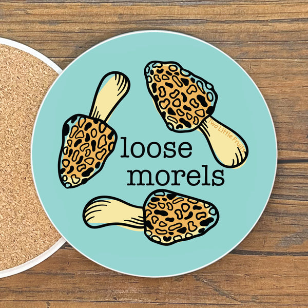A round coaster with a cartoon image of leopard-print mushrooms and the text "Loose Morels" on it.