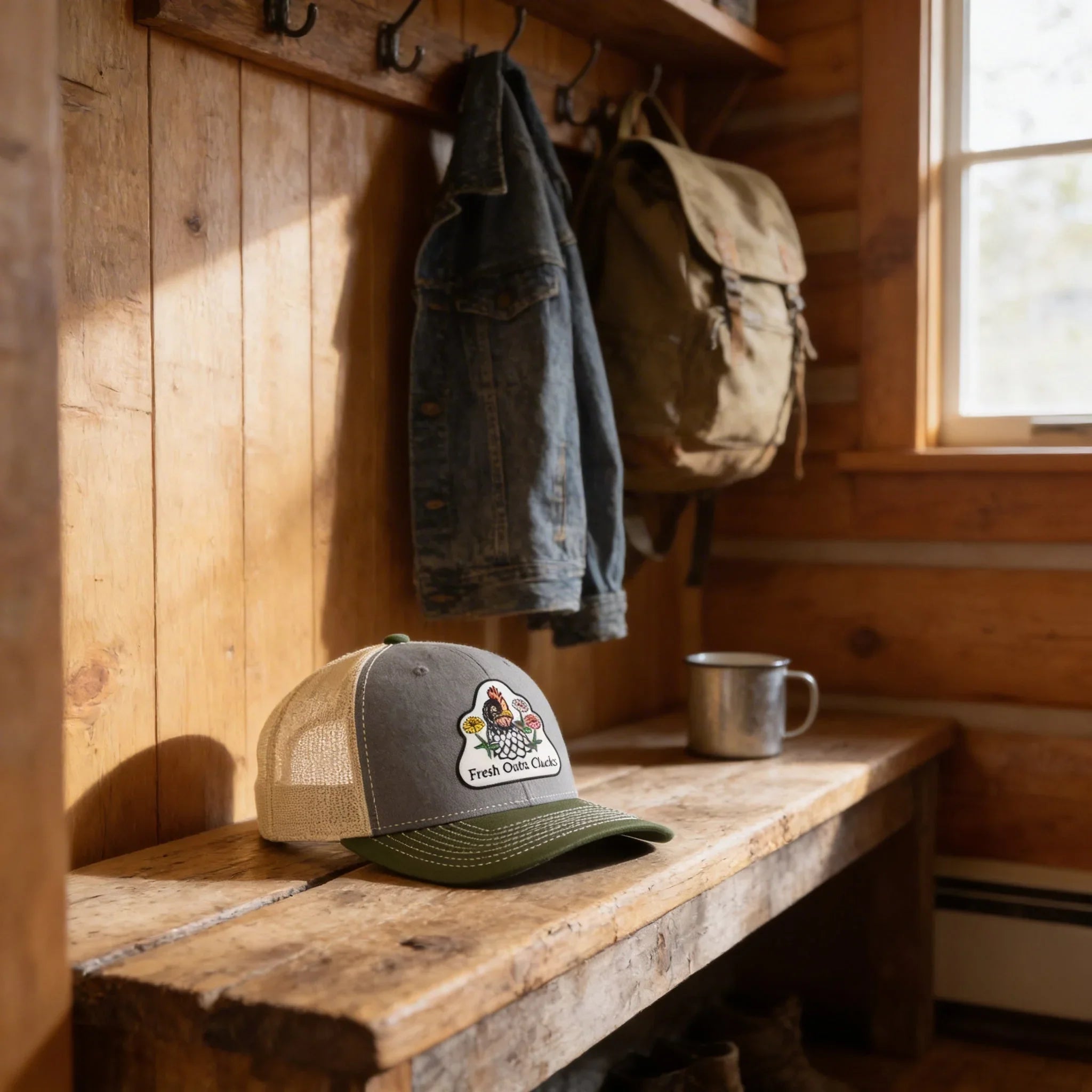 a wooden bench with a hat and a mug on it, set against a wooden wall with a coat rack and a backpack hanging on it.