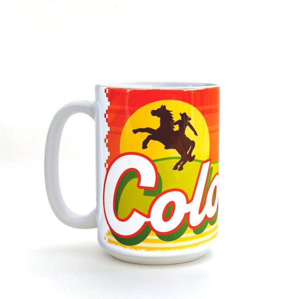 Stylish ceramic mug featuring a colorful design with a sunset, horses, and the word 'Colorado', perfect for enjoying your favorite coffee.