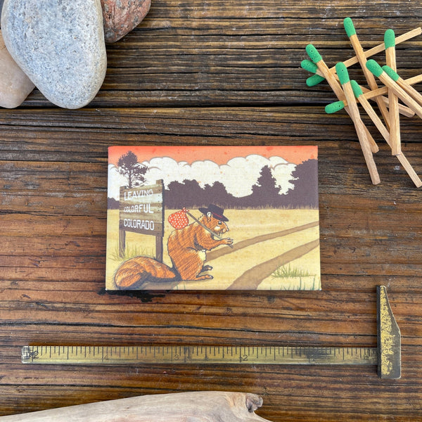 Happy Trails Hobo Squirrel Magnet featuring a whimsical squirrel on a journey, perfect for adding charm to your home with decorative fridge magnets.