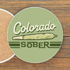 Colorful Colorado Sober Cannabis Drink Coaster featuring a playful design with a cannabis joint. Perfect for adding style to your drinks.