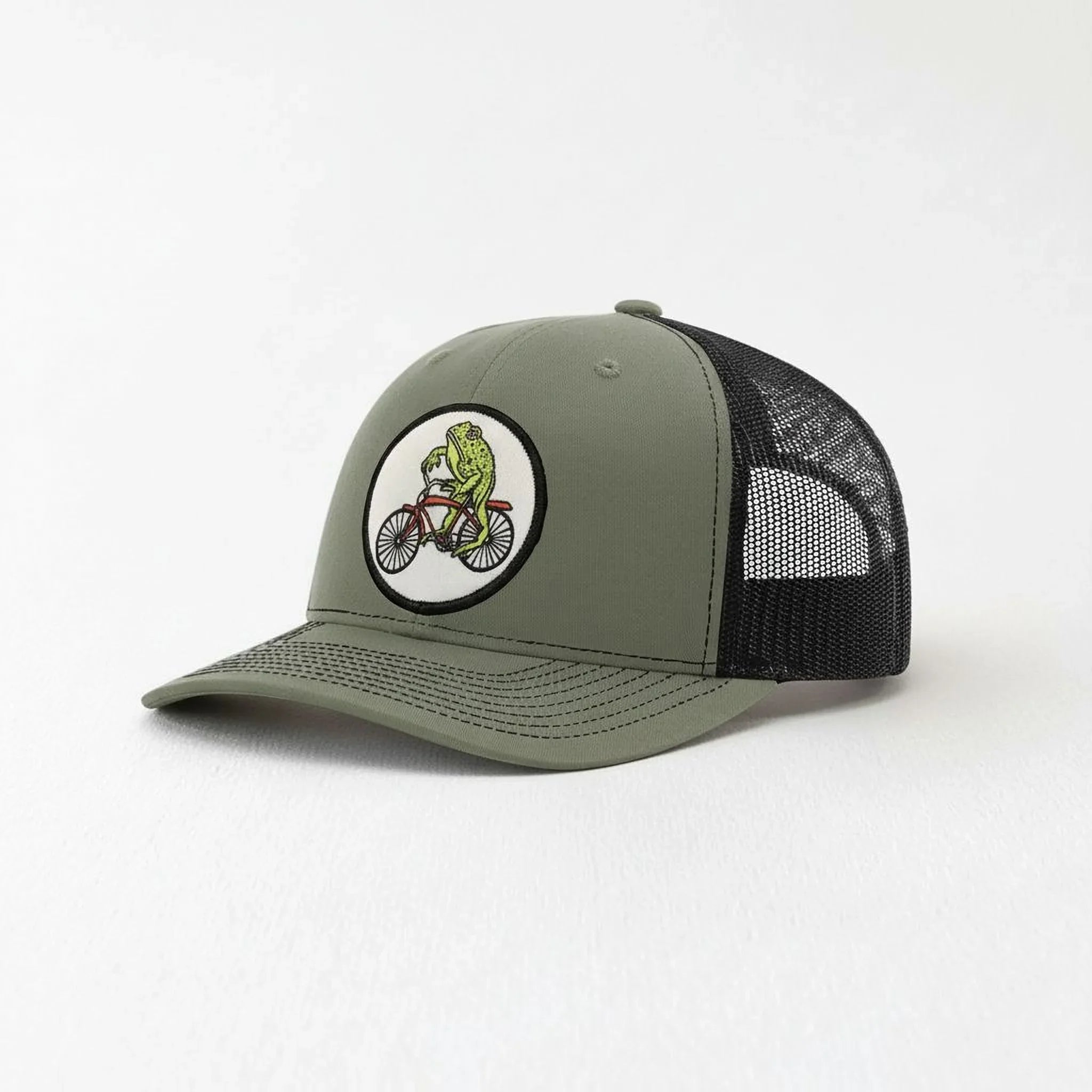 A green baseball cap with a black mesh panel and a circular patch on the front, depicting a person riding a bicycle.