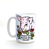 Close-up of Funny Pig Coffee Mug illustrating the charming phrase 'Don’t Go Bacon My Heart' with floral elements, ideal for adding humor to your morning.