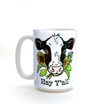 Hey Y'all Cow Coffee Mug showcasing a charming cow graphic with flowers, designed for those who enjoy a cheerful coffee experience. 15 oz heavy-duty ceramic.