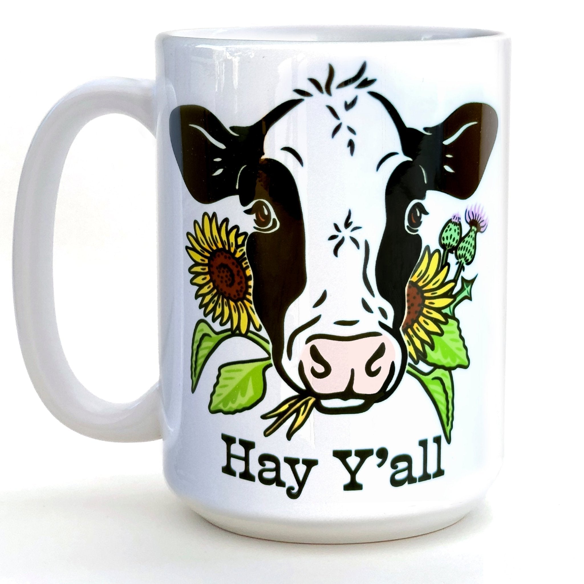 Hey Y'all Cow Coffee Mug featuring a friendly cow design with sunflowers, perfect for coffee lovers. 15 oz heavy-duty ceramic, microwave and dishwasher safe.