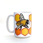 Side view of the Honeybee Coffee Mug - 15 Oz Heavy-Duty Ceramic showcasing a cheerful honeybee design on a bright hexagon pattern, ideal for coffee lovers.