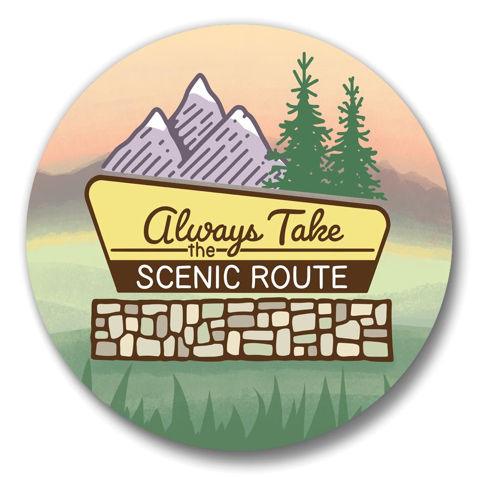 a sign that says "Always Take the Scenic Route" with mountains, pine trees, and a sunset in the background.