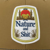 A patch with the text "Nature and Shit" and an image of a mountain landscape with a sunset.