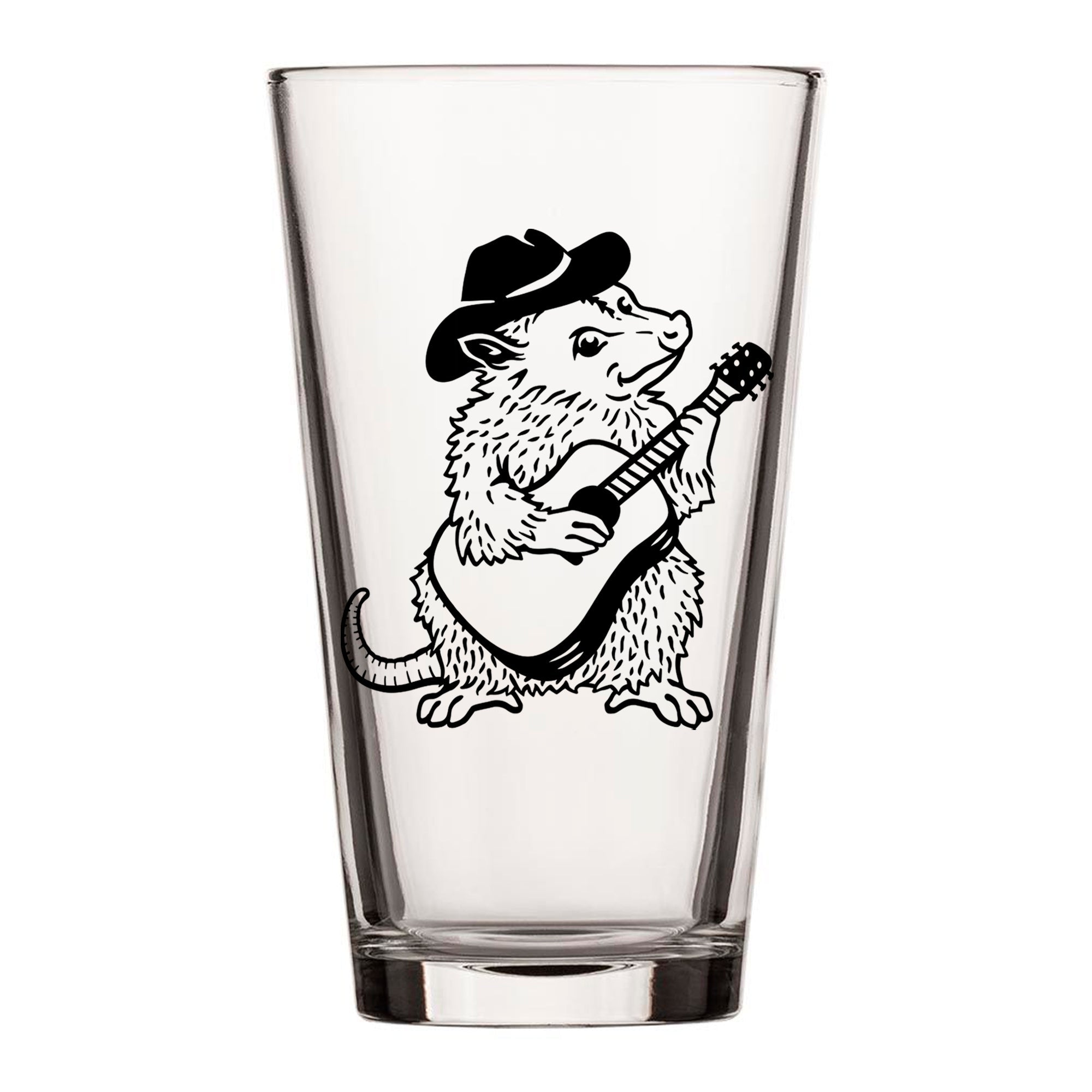 A glass with a black and white illustration of a furry animal, possibly a rat or a mouse, playing a guitar.