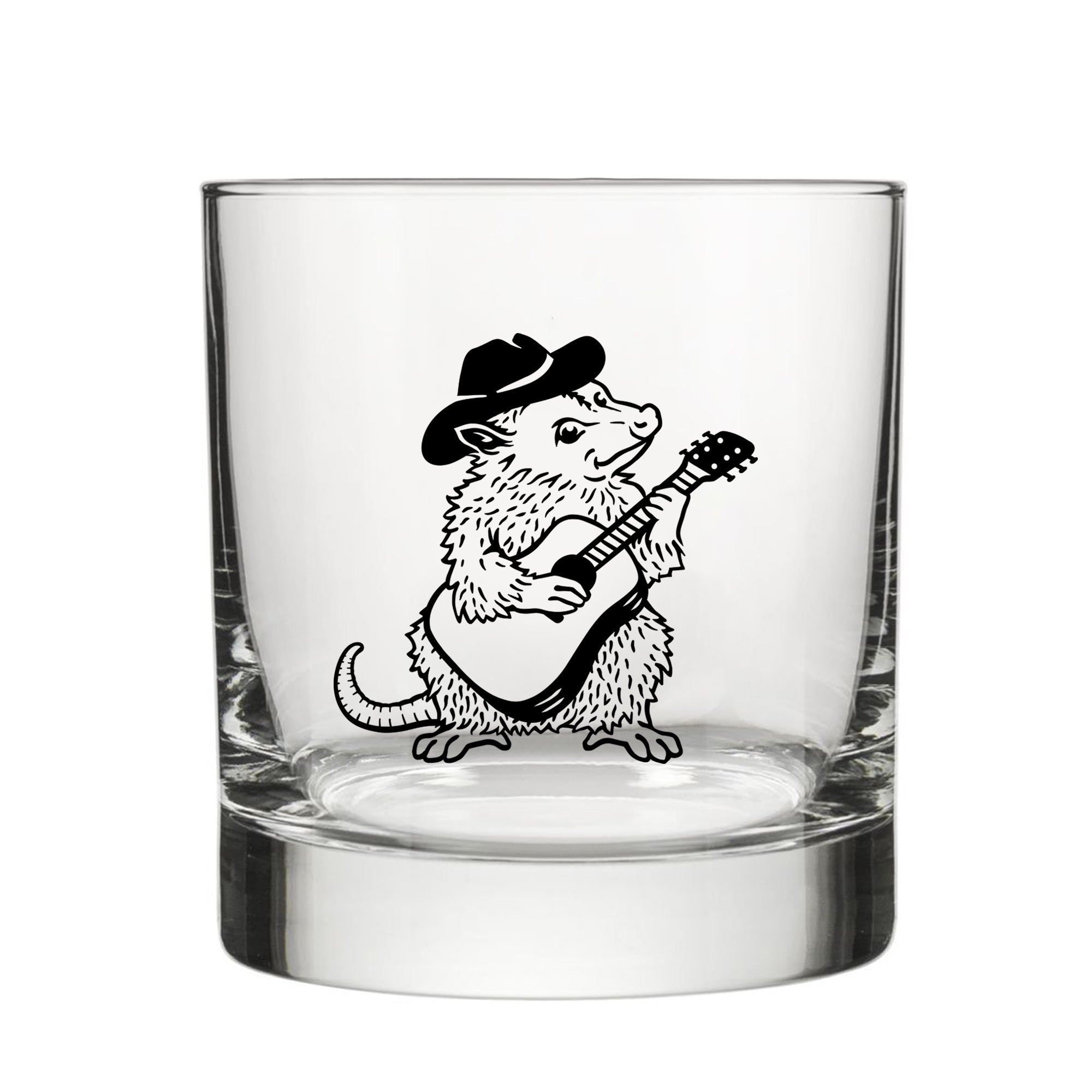 A glass with a black and white illustration of a furry animal, possibly a rodent or a small mammal, playing a guitar.