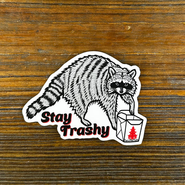 Whimsical raccoon sticker featuring the phrase 'Stay Trashy', showcasing a cartoon raccoon clutching a takeout box, perfect for quirky decor or as a fun gift.