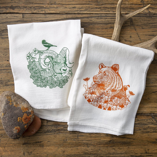Cheerful Ram And Bear Kitchen Towel Set featuring a green Bighorn ram and an orange Grizzly bear, perfect for brightening your kitchen. Made from 100% cotton, this cotton tea towel set is durable and eco-friendly.