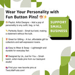 The image is a promotional graphic for a company called "Playful, Artful Designs" that offers custom-made fun button pins. The pin design features a star and a paintbrush, and the company is designed by users, just for them. The pins are described as "Great for gifting," "Easy to Wear & Swap," and "Designed by Us," and the company is located in a backyard studio. The image includes a call to action to "Find your new favorite pins at TwoLittleFruits.com!"