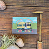 Sleepin' Around Fridge Magnet displaying a delightful illustration of a yellow camping trailer with a rainbow, perfect for brightening up your fridge.