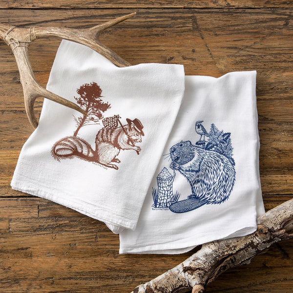 Squirrel and Beaver Tea Towel Set featuring a chocolate brown Hobo Squirrel and a blue Beaver design, showcasing the fun and unique cotton tea towels from Two Little Fruits.