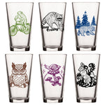 Unique Beer Glass Set - Mix And Match 6 Animal 16 Oz Pint Glasses displaying a diverse array of fun illustrations, including a frog, owl, and stay trashy raccoon, perfect for personalizing your drinkware.