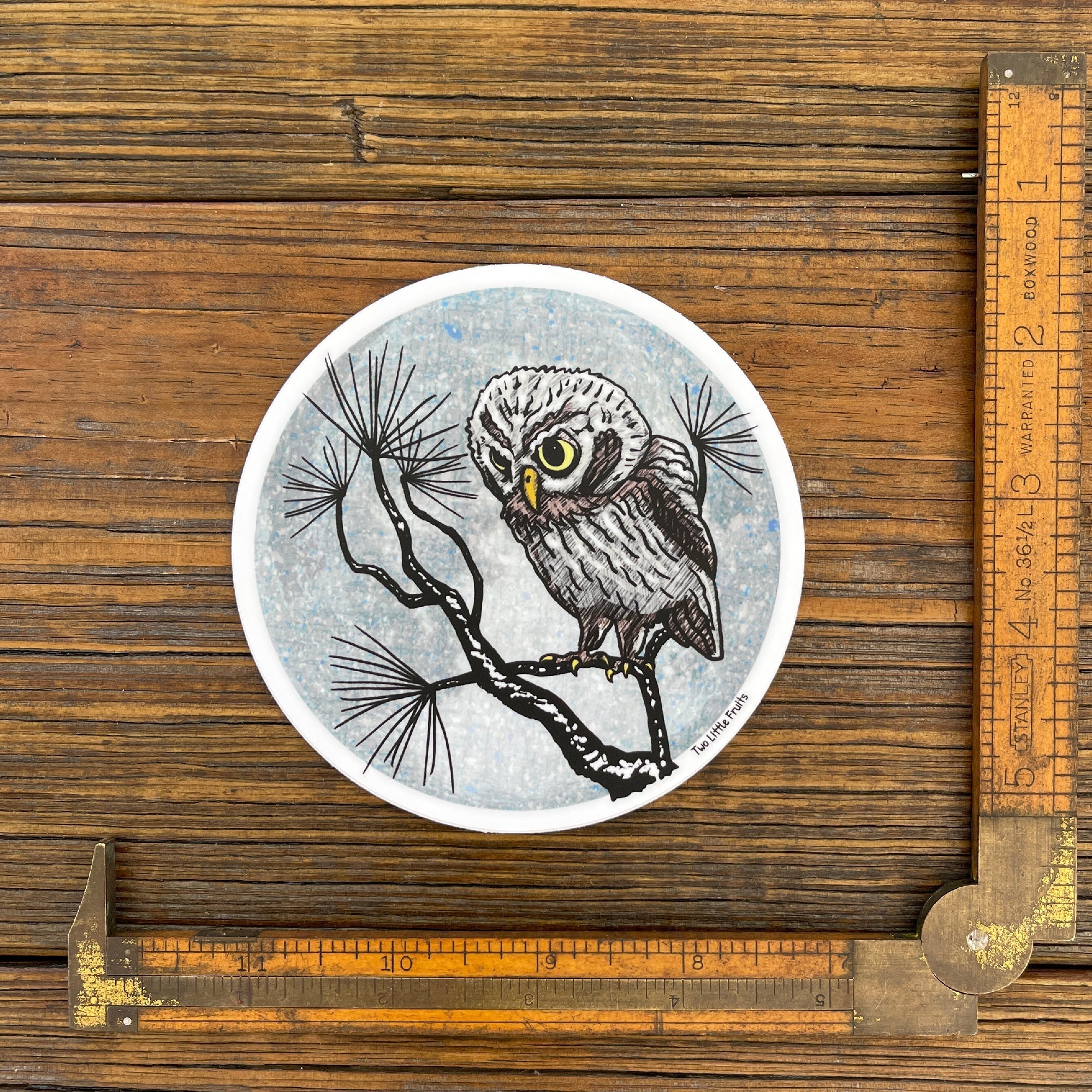 Charming Winter Watch Owl Sticker shown with a ruler, highlighting its size. This high-quality owl vinyl sticker by Two Little Fruits adds flair to any surface!