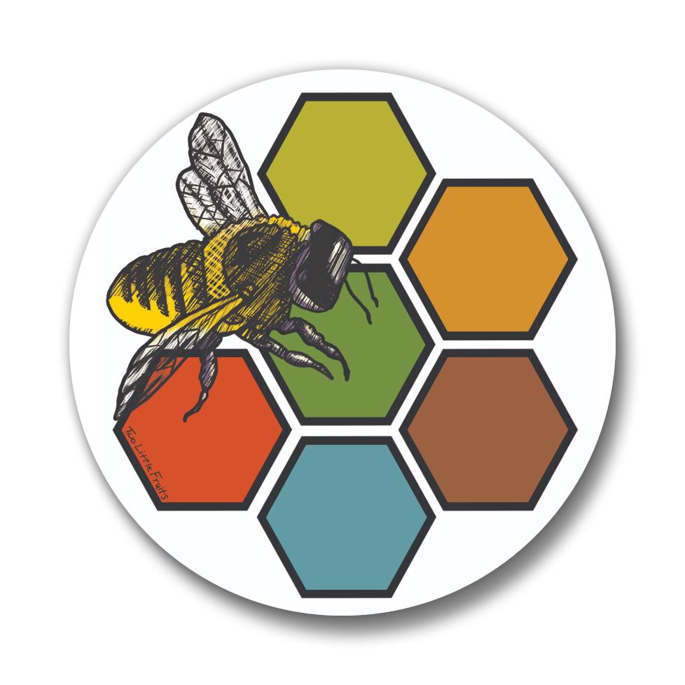 Close-up of the bee button pin showcasing an intricate illustration of a bee surrounded by colorful hexagons, perfect for accessories or gifts.