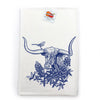 Vibrant blue longhorn steer colorful tea towel displayed with lavender and a knife on a wooden surface, emphasizing its artistic design.