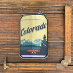 Colorado Beer Sticker - Durable Waterproof Vinyl Decal featuring a canoe and mountain design, showcasing vibrant colors on a beer can-shaped sticker.