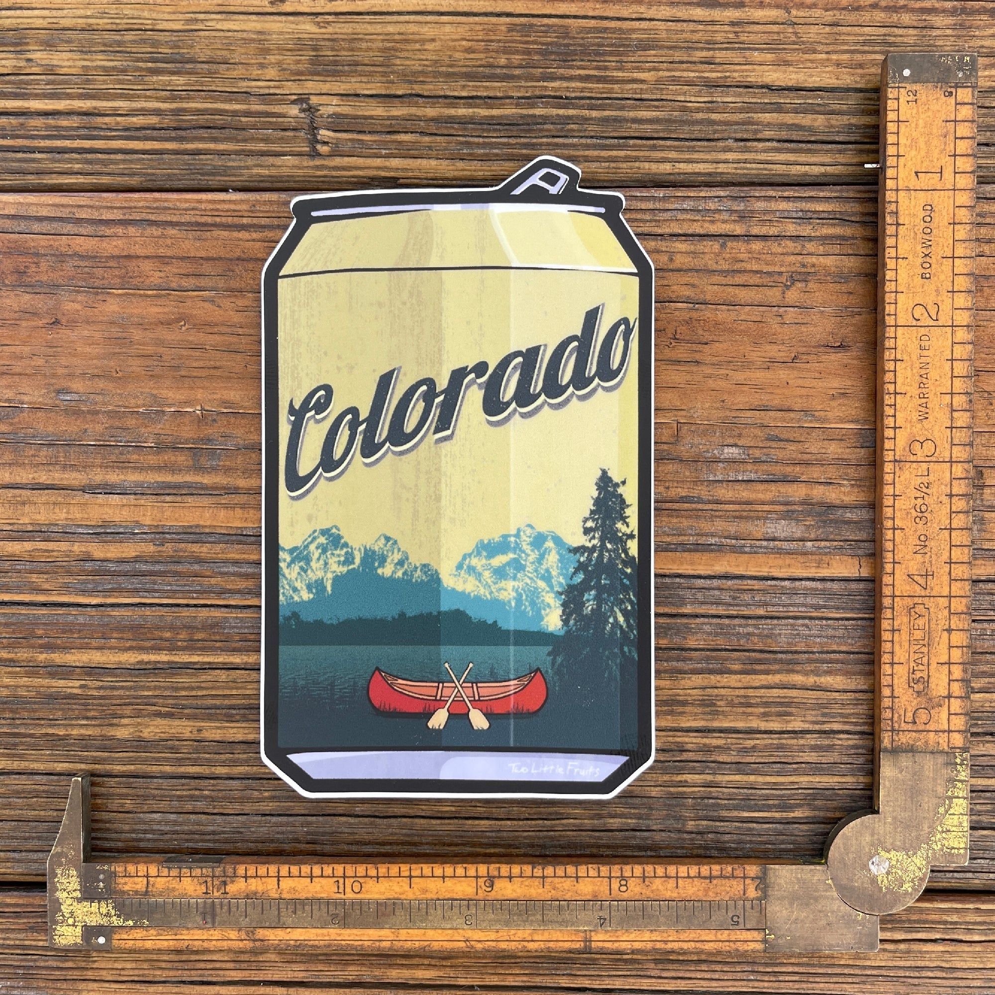 Colorado Beer Sticker - Durable Waterproof Vinyl Decal featuring a canoe and mountain design, showcasing vibrant colors on a beer can-shaped sticker.