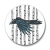 Close-up of a crow button pin showcasing artistic details of a crow against a background of vertical lines.