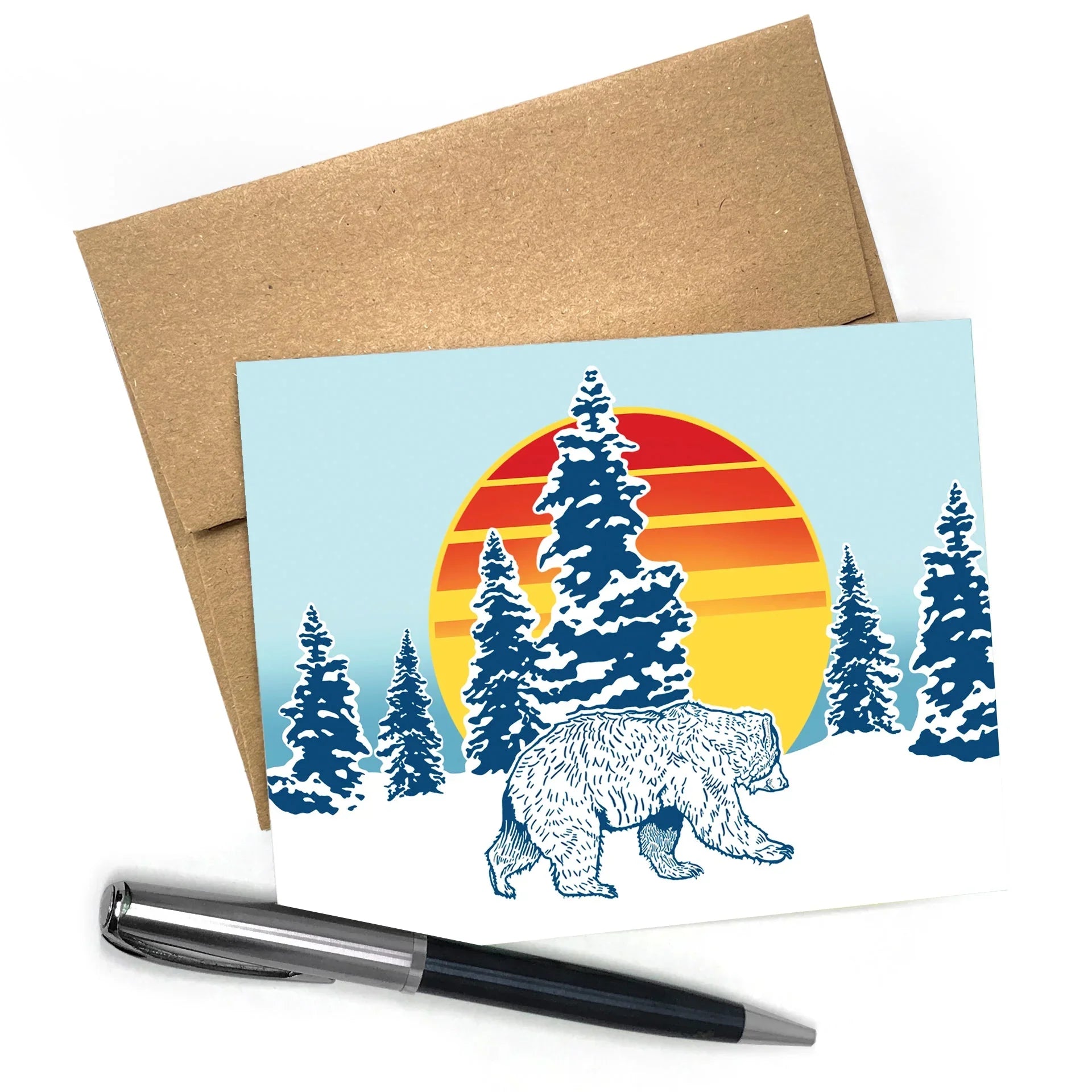 Cute Animal Cards: Winter Bear Blank Greeting Card A2 Size with Envelope featuring a walking bear with a colorful sunset and snowy pine trees in the background.