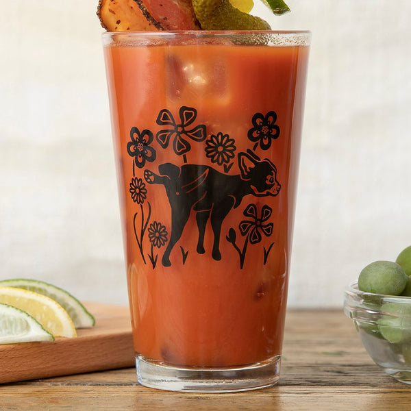 Cheerful Dog Beer Glass featuring a playful pup and flowers design, perfect for enjoying your favorite beverages.