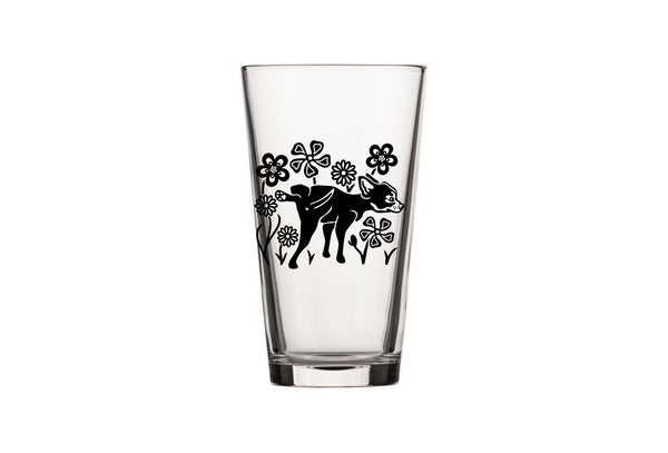 Festive setting with the Dog Beer Glass surrounded by beer and snacks, adding a fun touch to any celebration.